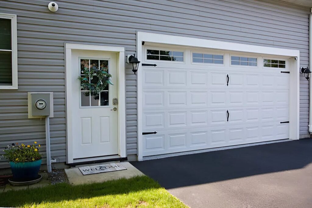 Cleanly painted garage door and exterior siding in soft gray tones by a professional painter in Frederick, MD