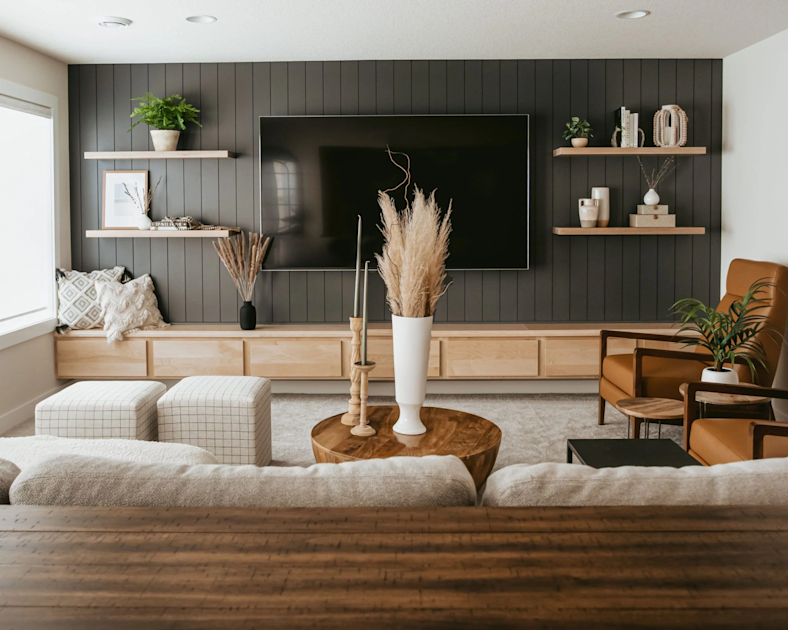 Living room with dark charcoal accent wall and warm neutral palette by a painting company in Walkersville, MD