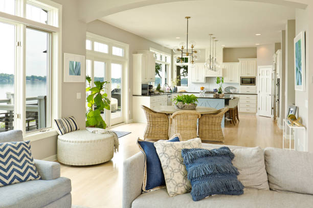 Open-concept living room and kitchen with warm off-white walls and crisp white trim by a painting company in Clarksburg, MD